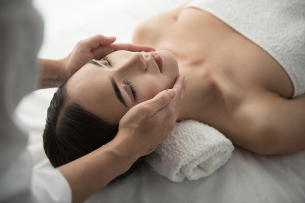 woman lying on table getting bespoke facial